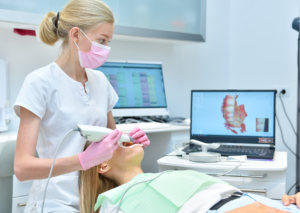 Ortodoncista evalúa la boca de una paciente con un scanner intraoral. Tema: Extracción de premolares para ortodoncia. Blog Everest Life